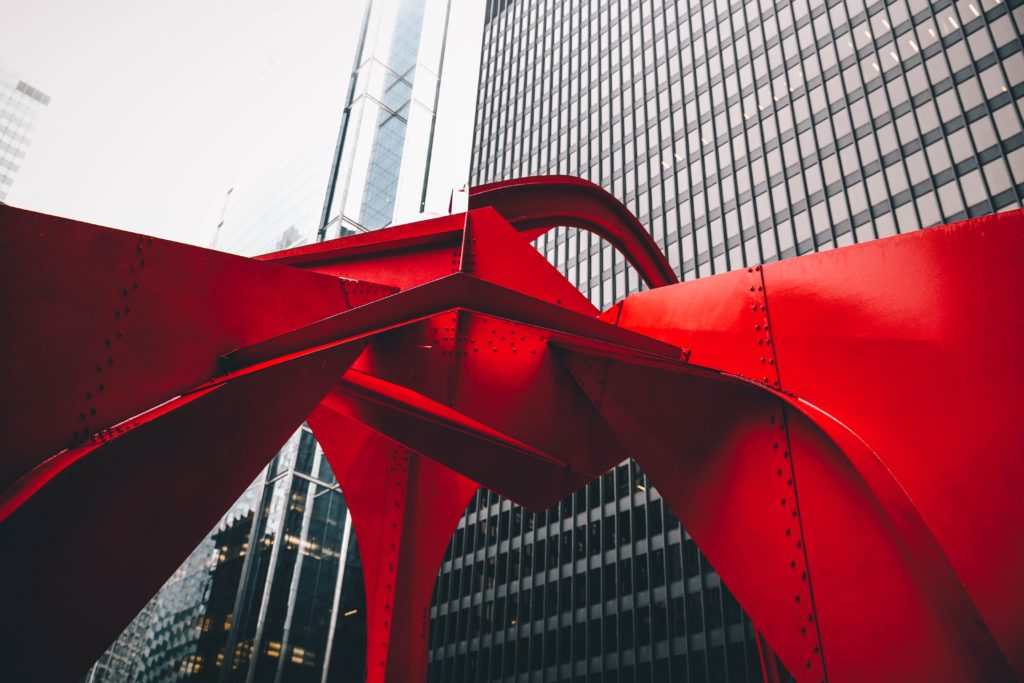 Ground image of red metal sculpture called Flamingo