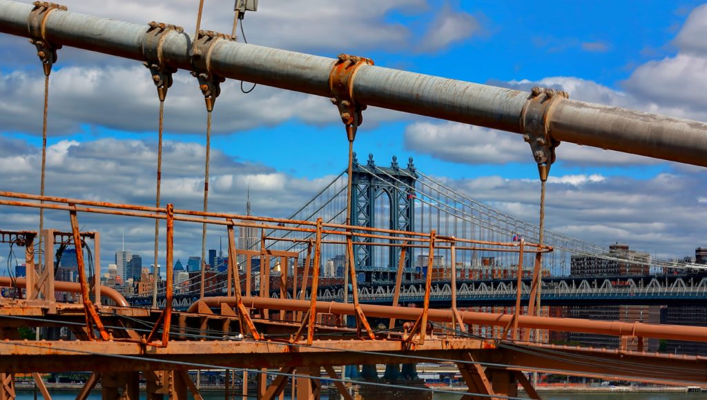 metal frames of bridge with New York city background